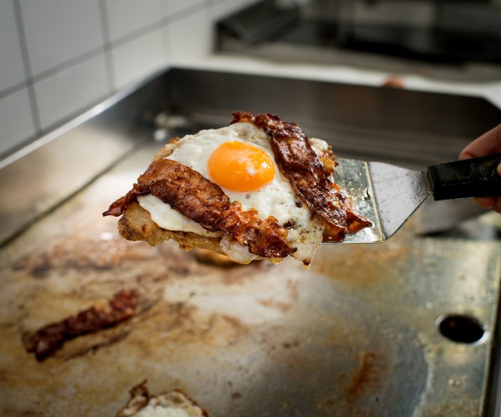 Preparation of bread with fried egg and bacon